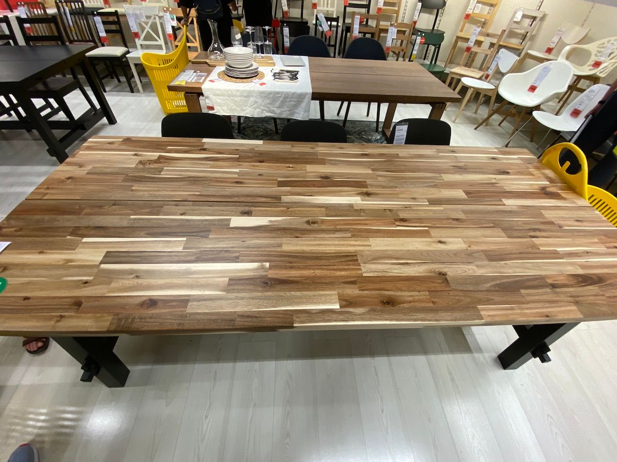 Large wooden desk with different colored slats (light brown to dark brown)